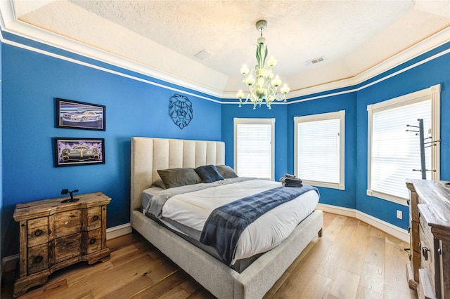 5302 Val Verde St, Houston, TX 77056 - bedroom featuring a tray ceiling, a chandelier, wood-type flooring, and baseboards