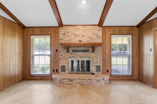 534 W Hufsmith Rd, Tomball, TX 77375 - unfurnished living room featuring wooden walls, a fireplace, tile patterned floors, and ornamental molding