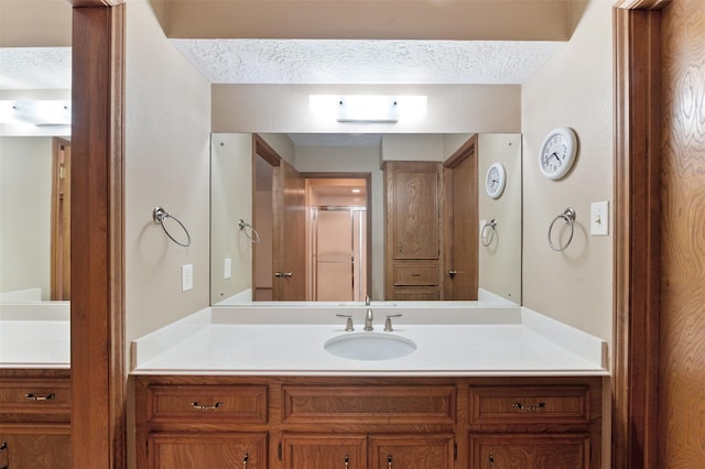 534 W Hufsmith Rd, Tomball, TX 77375 - full bathroom with vanity, a stall shower, and a textured ceiling