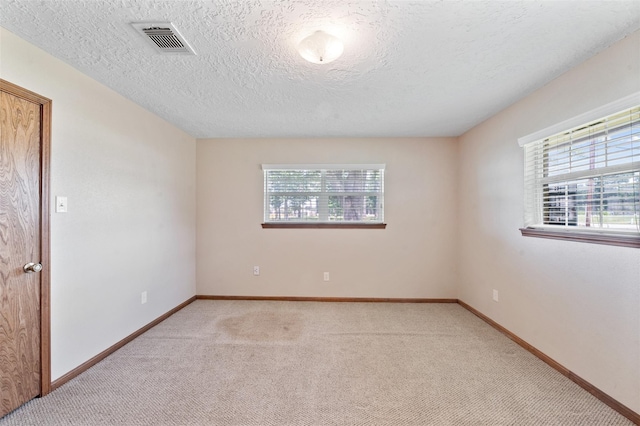 534 W Hufsmith Rd, Tomball, TX 77375 - carpeted empty room with baseboards and a textured ceiling
