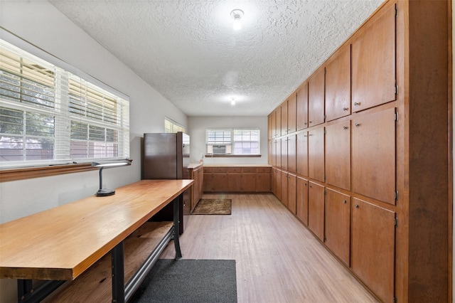 534 W Hufsmith Rd, Tomball, TX 77375 - kitchen with light wood-type flooring, a textured ceiling, cooling unit, brown cabinets, and light countertops