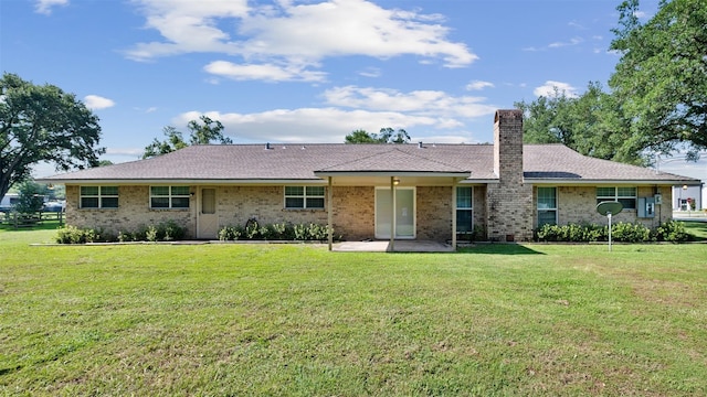 534 W Hufsmith Rd, Tomball, TX 77375 - view of front of home featuring a front yard, a patio, a chimney, and brick siding
