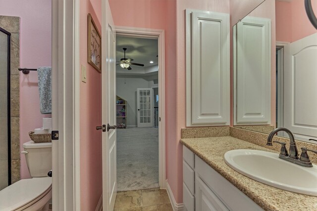 21603 Fairhaven Creek Dr, Cypress, TX 77433 - bathroom with vanity, toilet, a ceiling fan, baseboards, and stone finish flooring