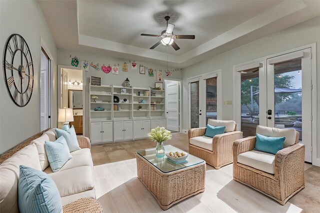 21603 Fairhaven Creek Dr, Cypress, TX 77433 - living area featuring a tray ceiling, a ceiling fan, and french doors
