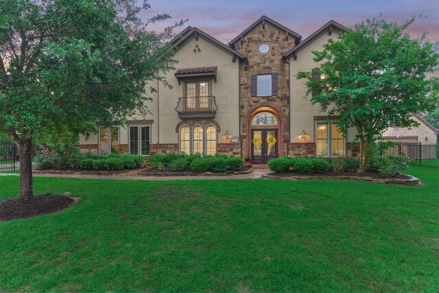 21603 Fairhaven Creek Dr, Cypress, TX 77433 - view of front of property featuring french doors, stone siding, stucco siding, and a lawn
