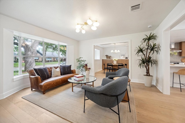4411 Colchester St, Houston, TX 77018 - living area with a chandelier, light wood-style floors, and plenty of natural light