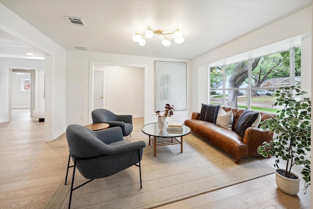 4411 Colchester St, Houston, TX 77018 - living area featuring light wood-style floors, baseboards, and a chandelier