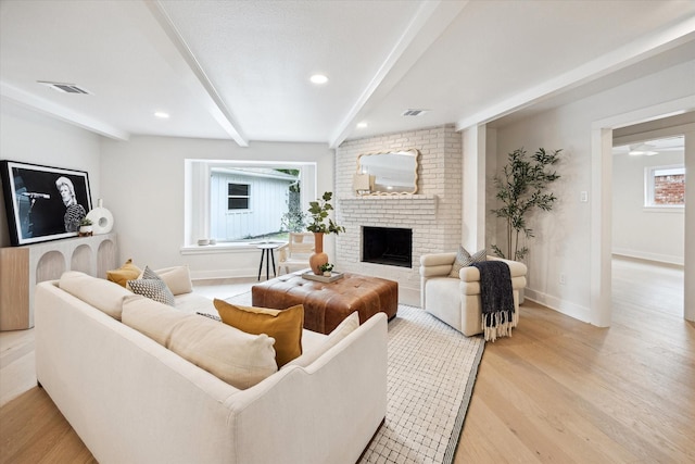 4411 Colchester St, Houston, TX 77018 - living area with beamed ceiling, a brick fireplace, light wood-style flooring, baseboards, and recessed lighting