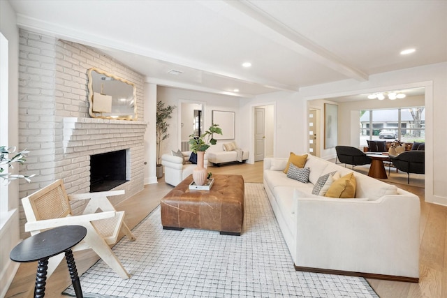 4411 Colchester St, Houston, TX 77018 - living room with a brick fireplace, beamed ceiling, recessed lighting, light wood-style floors, and a chandelier