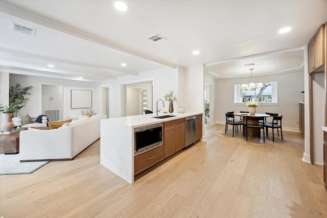 4411 Colchester St, Houston, TX 77018 - kitchen featuring a sink, dishwasher, built in microwave, light countertops, and brown cabinetry