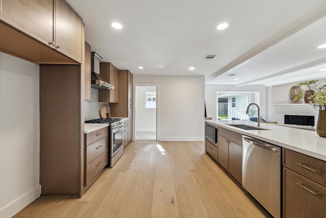 4411 Colchester St, Houston, TX 77018 - kitchen featuring stainless steel appliances, a sink, baseboards, light countertops, and tasteful backsplash