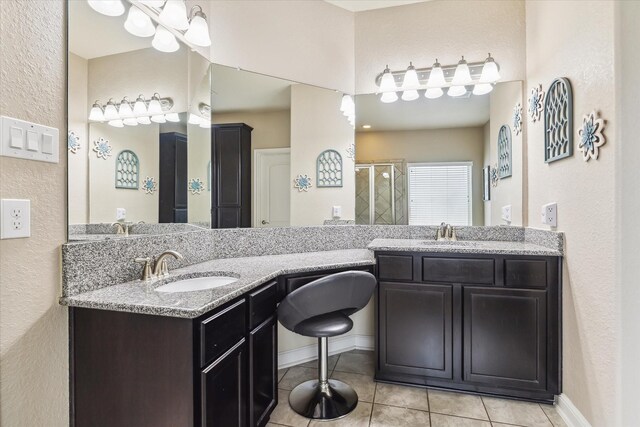 4914 Mountain Maple Trl, Rosenberg, TX 77471 - full bathroom featuring tile patterned floors, double vanity, a textured wall, and a shower stall