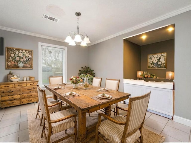 701 Alamo St, El Campo, TX 77437 - dining space with ornamental molding, light tile patterned floors, a chandelier, and baseboards