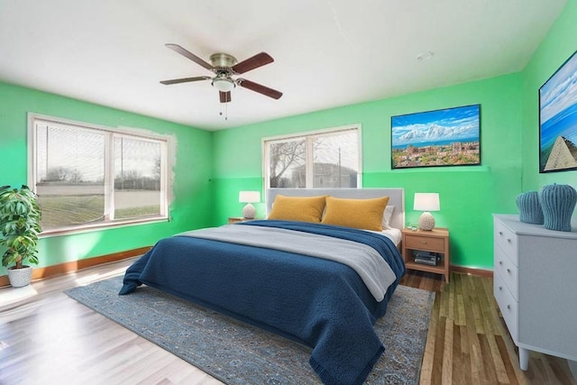 701 Alamo St, El Campo, TX 77437 - bedroom with wood finished floors, baseboards, and ceiling fan
