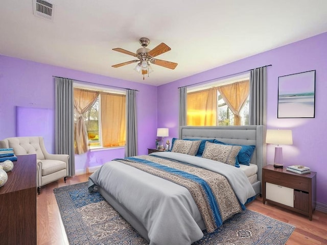 701 Alamo St, El Campo, TX 77437 - bedroom featuring multiple windows, light wood-type flooring, baseboards, and ceiling fan