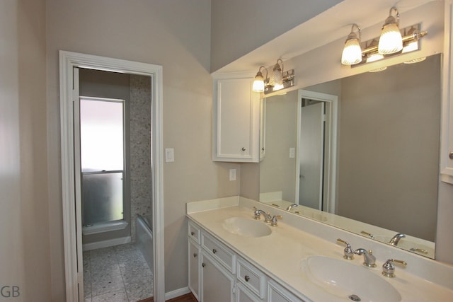 918 Longview Dr, Sugar Land, TX 77478 - bathroom with double vanity, baseboards, and a bathtub
