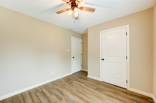 2525 29th Ave N, Texas City, TX 77590 - unfurnished bedroom with light wood finished floors, baseboards, and ceiling fan