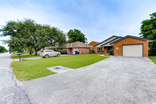 2525 29th Ave N, Texas City, TX 77590 - ranch-style home featuring a front lawn, brick siding, a garage, and concrete driveway