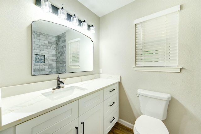 2525 29th Ave N, Texas City, TX 77590 - full bathroom with toilet, vanity, wood finished floors, and baseboards