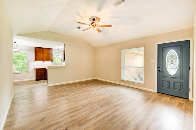2525 29th Ave N, Texas City, TX 77590 - unfurnished living room with a ceiling fan, light wood-type flooring, lofted ceiling, and baseboards