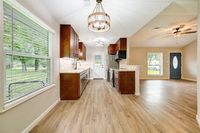 2525 29th Ave N, Texas City, TX 77590 - kitchen featuring appliances with stainless steel finishes, a chandelier, light countertops, and tasteful backsplash