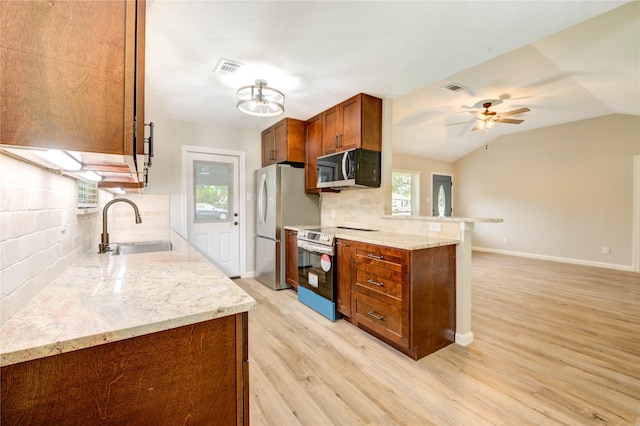 2525 29th Ave N, Texas City, TX 77590 - kitchen with stainless steel appliances, a sink, tasteful backsplash, light wood-style floors, and light stone countertops