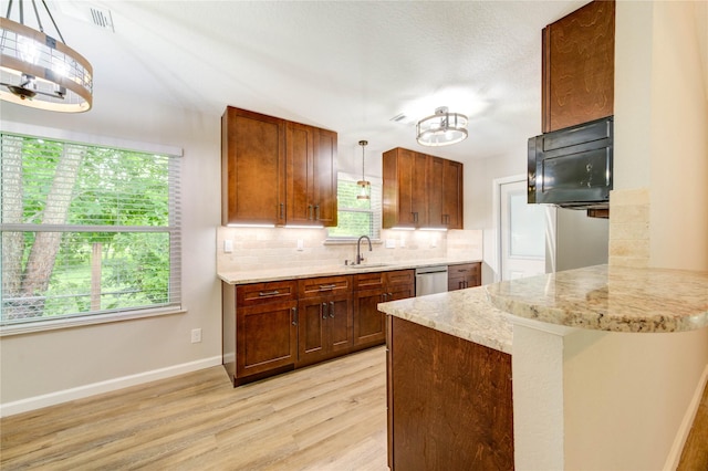 2525 29th Ave N, Texas City, TX 77590 - kitchen with a chandelier, a sink, stainless steel dishwasher, decorative backsplash, and light wood-style flooring