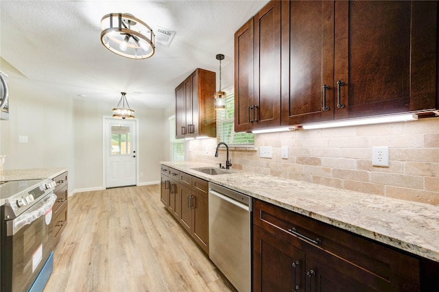 2525 29th Ave N, Texas City, TX 77590 - kitchen with stainless steel appliances, a sink, decorative backsplash, light wood-type flooring, and a chandelier