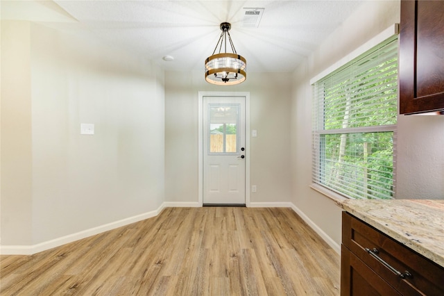 2525 29th Ave N, Texas City, TX 77590 - entryway featuring light wood-type flooring, a chandelier, and baseboards