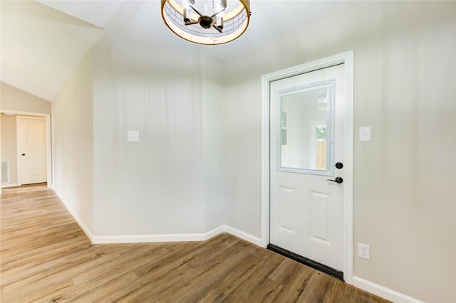 2525 29th Ave N, Texas City, TX 77590 - foyer entrance with light wood-style flooring, a chandelier, baseboards, and lofted ceiling
