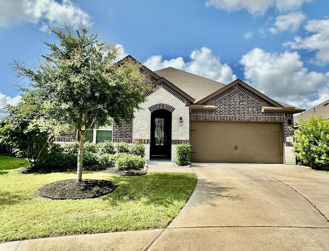 1007 Parsnip Acres Ct, Richmond, TX 77406 - french country style house featuring a garage, concrete driveway, a front lawn, brick siding, and stone siding
