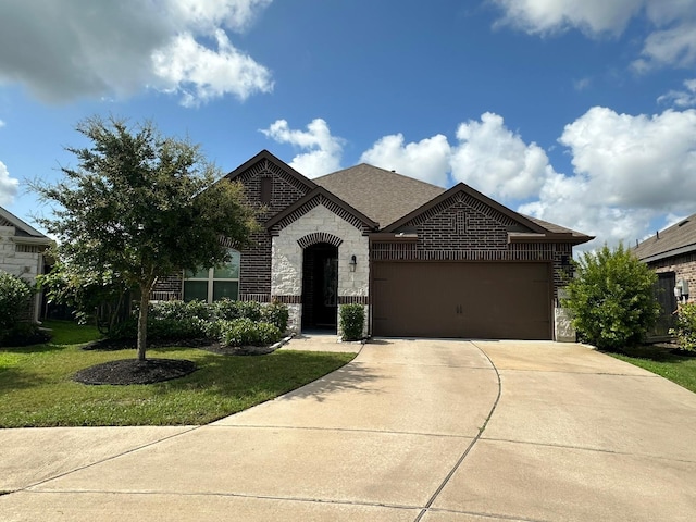1007 Parsnip Acres Ct, Richmond, TX 77406 - french country inspired facade featuring an attached garage, driveway, stone siding, a front yard, and brick siding