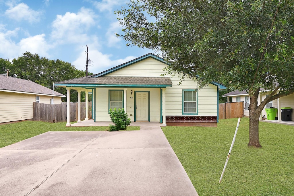 406 Collins Rd, Richmond, TX 77469 - view of front of house with covered porch and a shingled roof