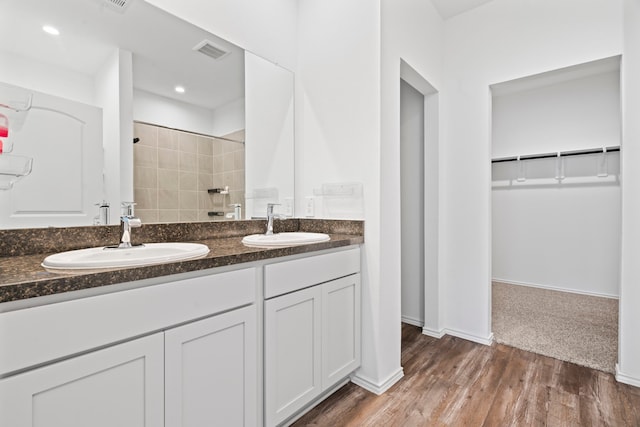 5115 Belmont Hill Ct, Spring, TX 77373 - full bath featuring tiled shower, double vanity, a walk in closet, wood finished floors, and baseboards