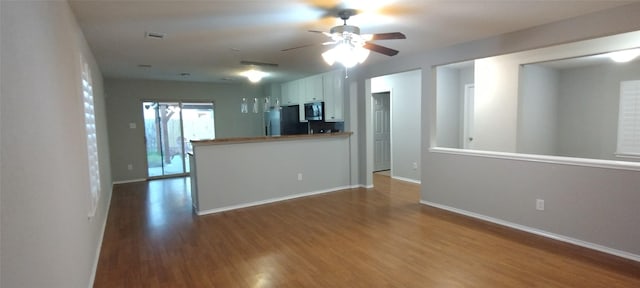 2518 Skyview Cove Ct, Houston, TX 77047 - unfurnished living room with wood finished floors, a ceiling fan, and baseboards