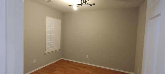 2518 Skyview Cove Ct, Houston, TX 77047 - unfurnished room with a chandelier, wood finished floors, and baseboards