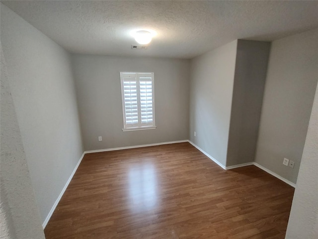2518 Skyview Cove Ct, Houston, TX 77047 - spare room with a textured ceiling, wood finished floors, and baseboards