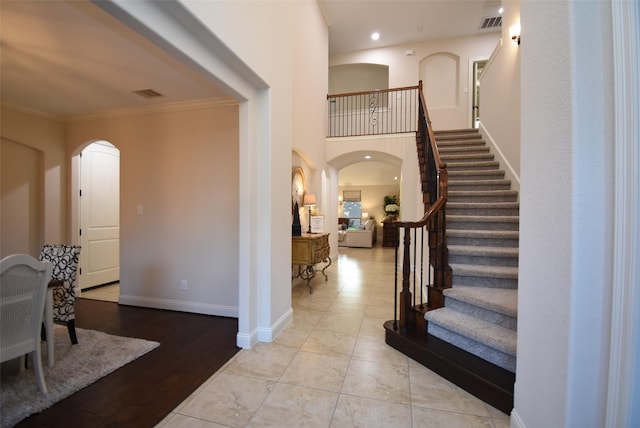 4511 Wickby St, Fulshear, TX 77441 - foyer entrance featuring arched walkways, ornamental molding, stairs, and recessed lighting