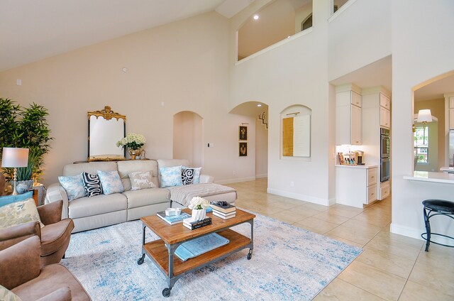 4511 Wickby St, Fulshear, TX 77441 - living area with arched walkways, light tile patterned flooring, and high vaulted ceiling