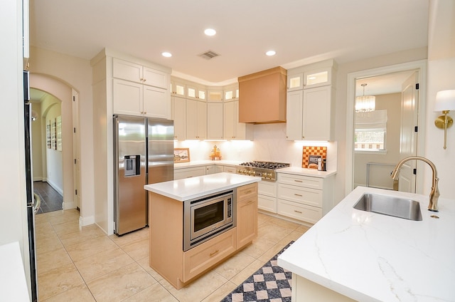 4511 Wickby St, Fulshear, TX 77441 - kitchen with appliances with stainless steel finishes, a center island, recessed lighting, glass insert cabinets, and light tile patterned floors