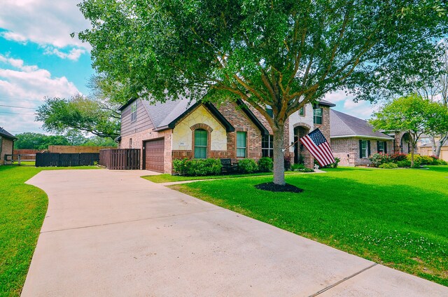 4511 Wickby St, Fulshear, TX 77441 - view of front of house with brick siding, concrete driveway, and stone siding