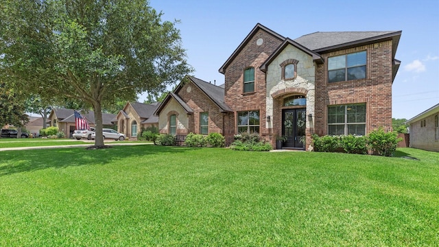 4511 Wickby St, Fulshear, TX 77441 - french country inspired facade with brick siding, a front lawn, and stone siding