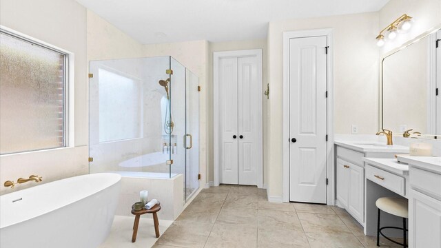 4511 Wickby St, Fulshear, TX 77441 - bathroom featuring vanity, a freestanding tub, a shower stall, and a closet