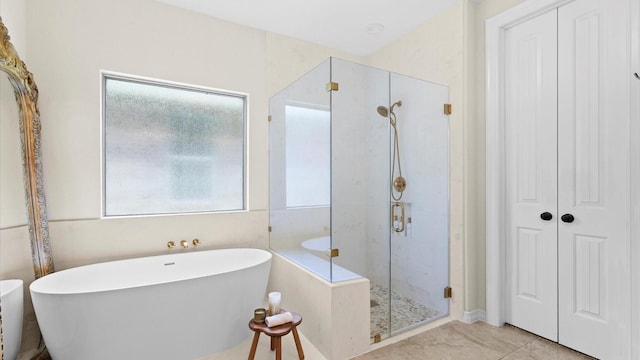 4511 Wickby St, Fulshear, TX 77441 - full bath featuring a shower stall, a freestanding bath, and tile patterned floors