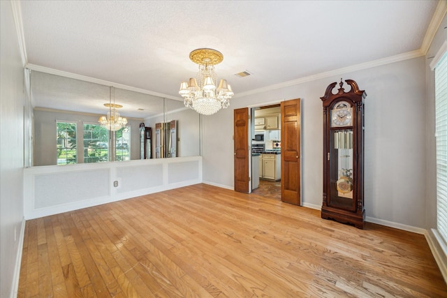5718 Glenmere Ln, Spring, TX 77379 - empty room with a chandelier, light wood finished floors, ornamental molding, and baseboards