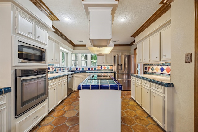 5718 Glenmere Ln, Spring, TX 77379 - kitchen with stainless steel appliances, crown molding, backsplash, tile countertops, and a sink