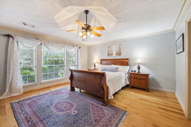 5718 Glenmere Ln, Spring, TX 77379 - bedroom with ornamental molding, light wood-style floors, a textured ceiling, baseboards, and ceiling fan