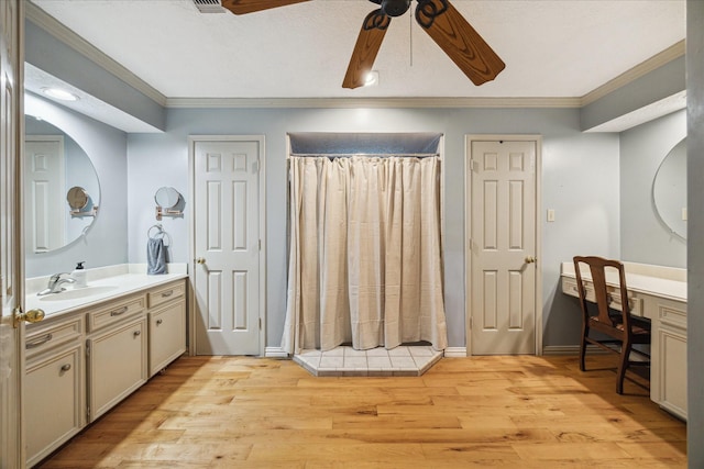 5718 Glenmere Ln, Spring, TX 77379 - full bathroom with ornamental molding, vanity, ceiling fan, wood finished floors, and a shower with shower curtain