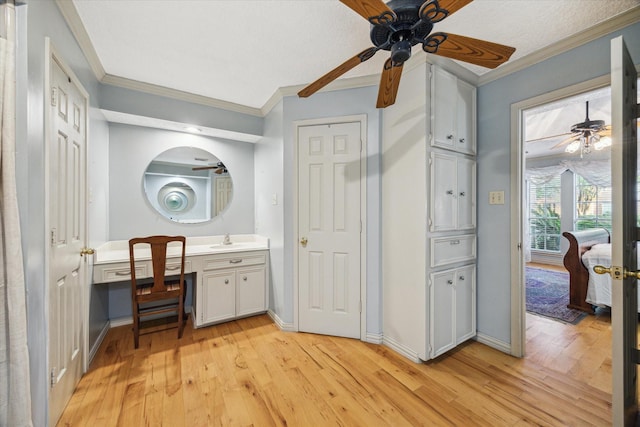 5718 Glenmere Ln, Spring, TX 77379 - bathroom with ceiling fan, wood-type flooring, ornamental molding, vanity, and baseboards