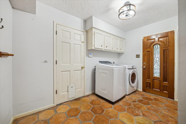 5718 Glenmere Ln, Spring, TX 77379 - washroom featuring washer and clothes dryer, cabinet space, a textured ceiling, and baseboards